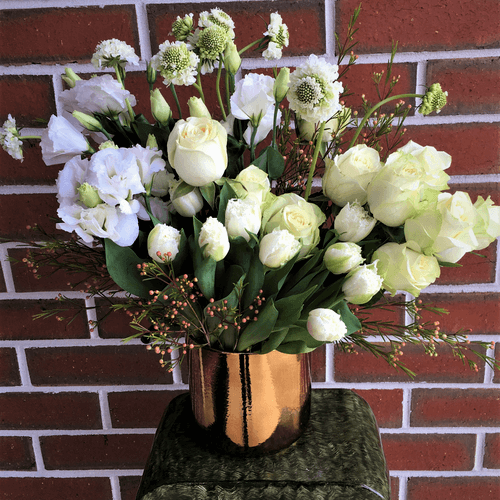 White flowers arrangement in acontainer. Available for same day delivery.