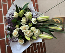 Elegant funeral sheaf with white roses and lilies