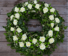 Medium sized white funeral wreath. Available for delivery.