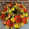 Funeral Flower wreath with orange gerberas, roses, tulips and yellow chrysanthemums.
