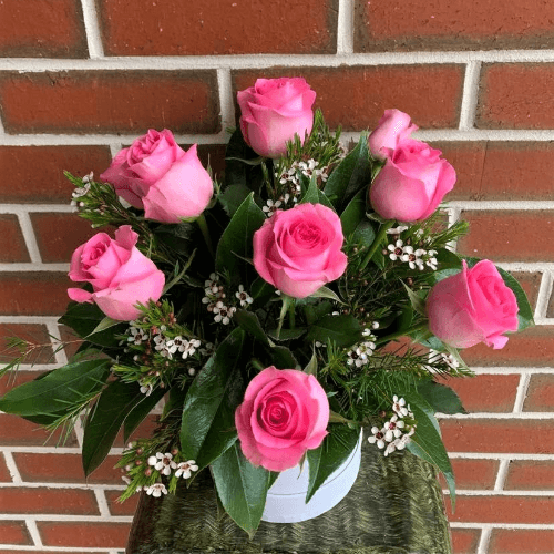 Pink roses arranged in a white hatbox