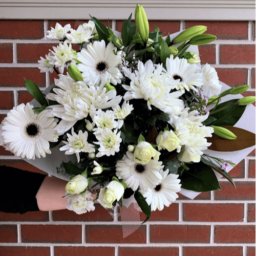 Bouquet of different white flowers.