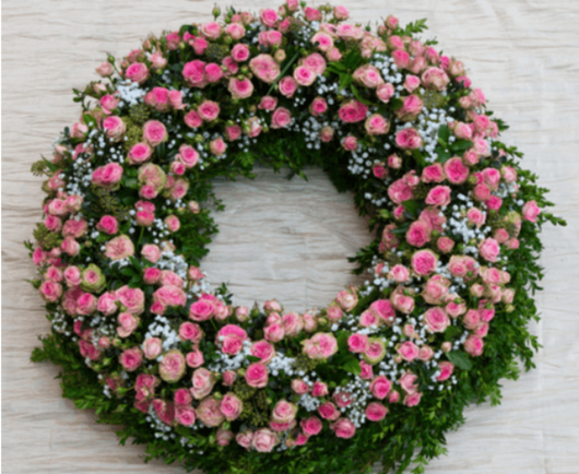 Large pink spray roses funeral wreath.