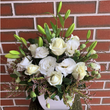 A selection of white flowers in a white ceramic container